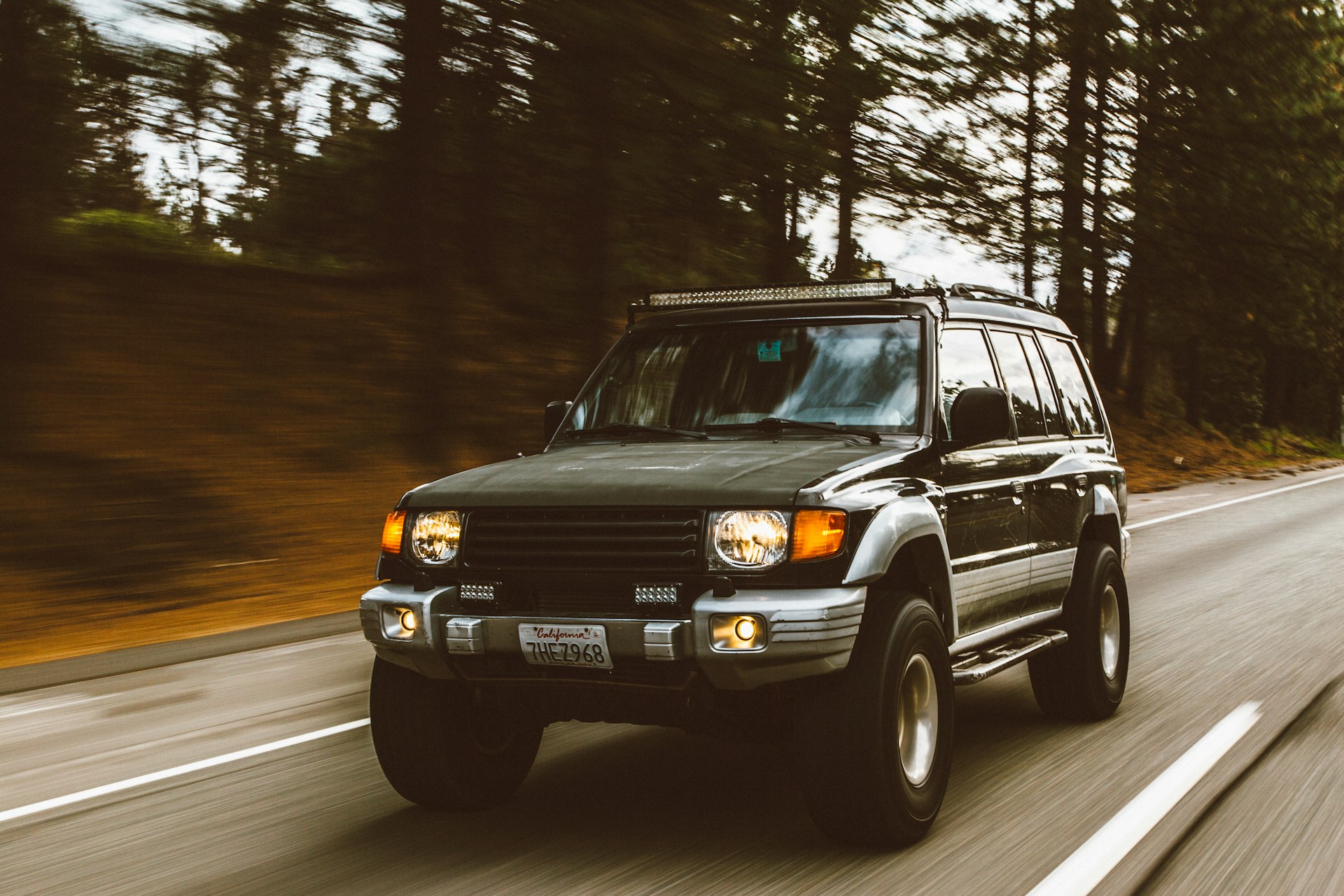 Compact car parked on a scenic road, ready for an exciting travel journey across landscapes.